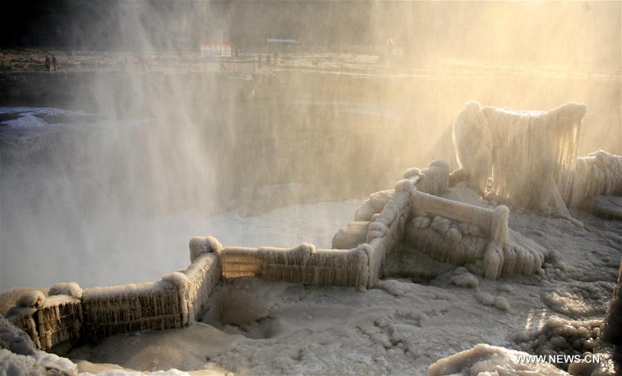 Visitors view frozen Hukou Waterfall on Yellow River