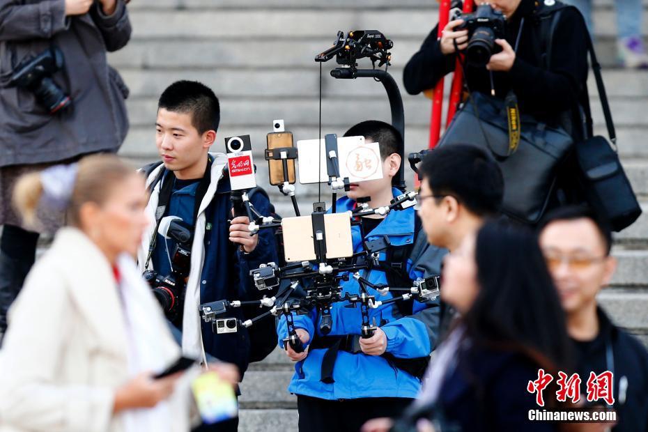 Journalist equipped with 'iron man' broadcast devices during Two Sessions