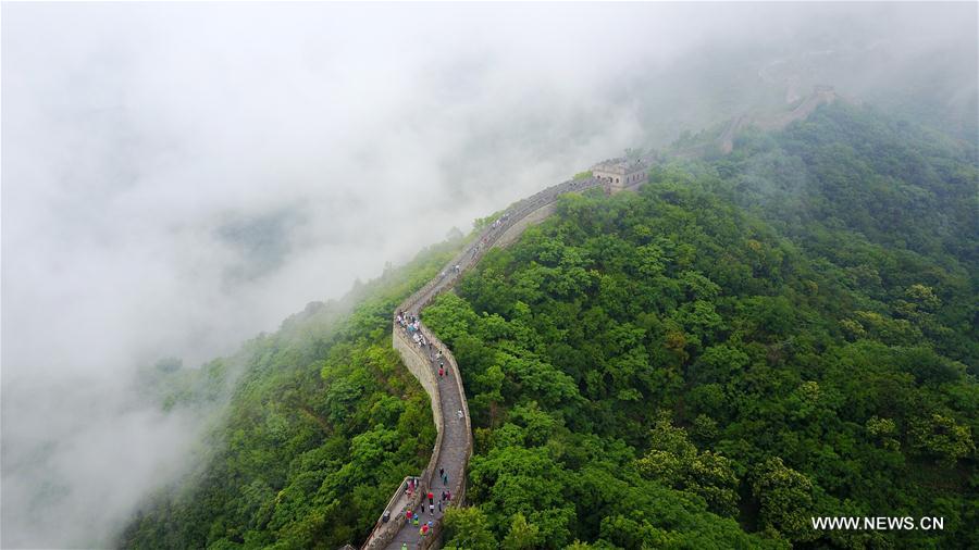 People visit Mutianyu section of Great Wall in mist and rain in Beijing