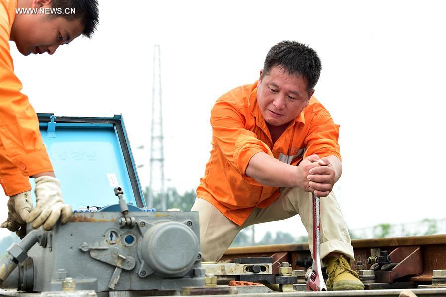 Workers keep working on posts in persistent summer heat