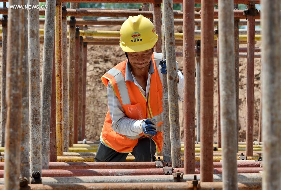 Builders work at construction site in hot summer in N China