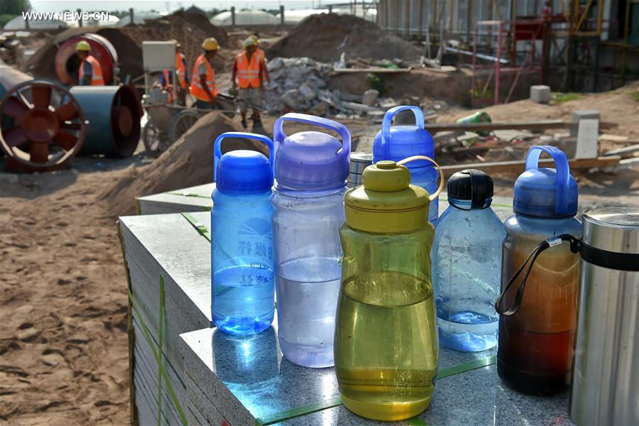 Builders work at construction site in hot summer in N China