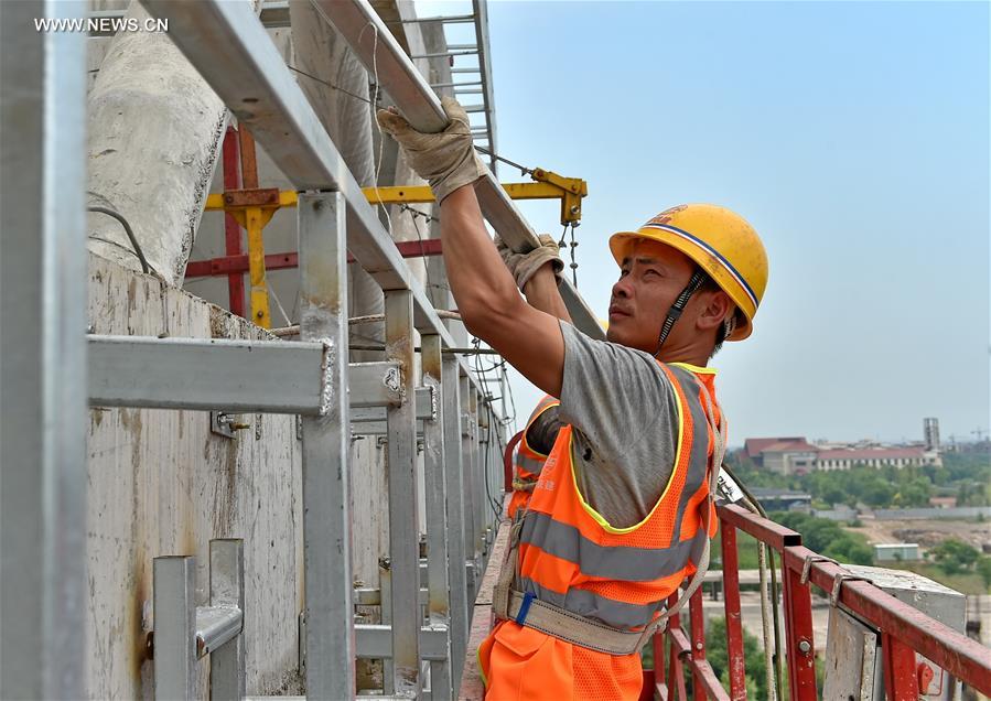 Builders work at construction site in hot summer in N China