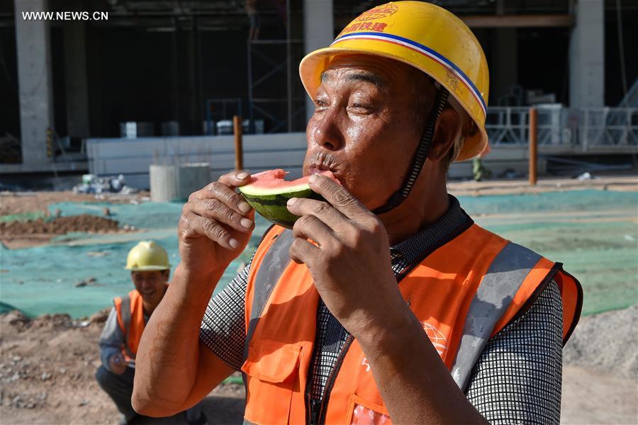 Builders work at construction site in hot summer in N China