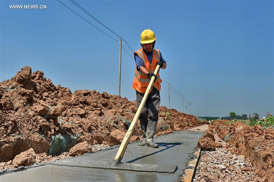 Builders work at construction site in hot summer in N China