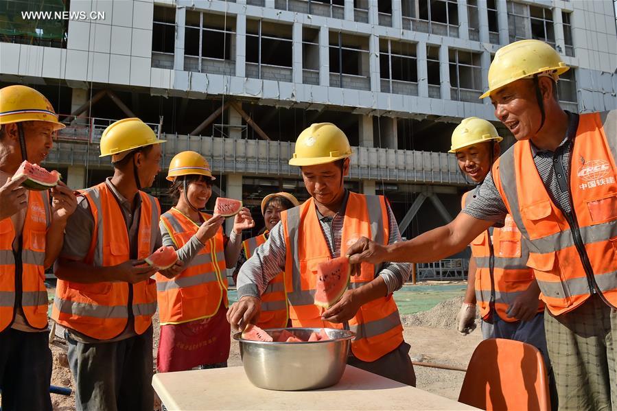 Builders work at construction site in hot summer in N China