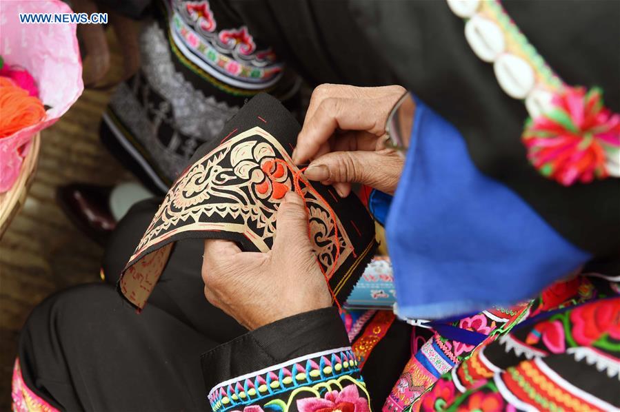 In pics: ethnic embroidery show in SW China's Yunnan