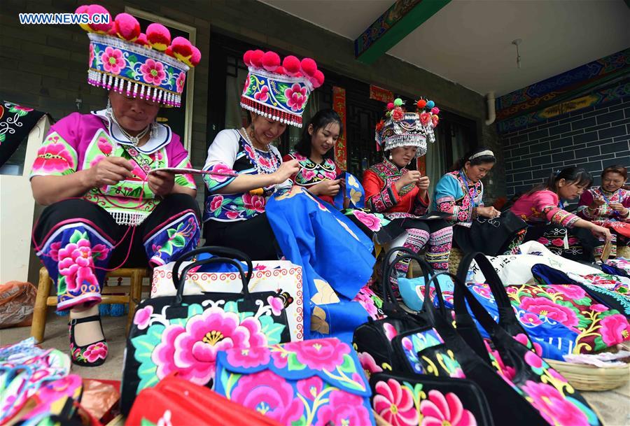 In pics: ethnic embroidery show in SW China's Yunnan