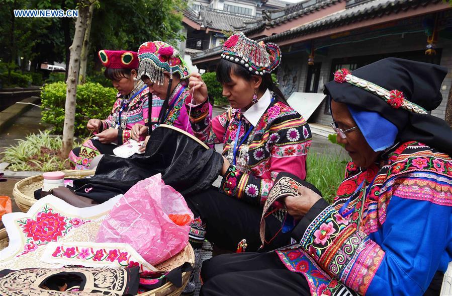 In pics: ethnic embroidery show in SW China's Yunnan