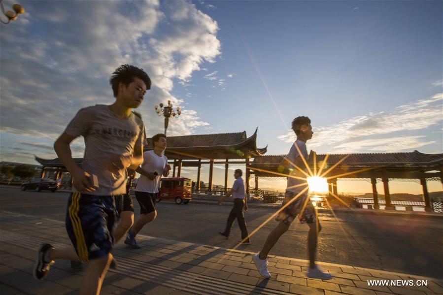 People enjoy outdoor exercises in summer day in China