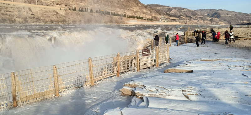 Rainbow and icicles appear at Hukou Waterfall