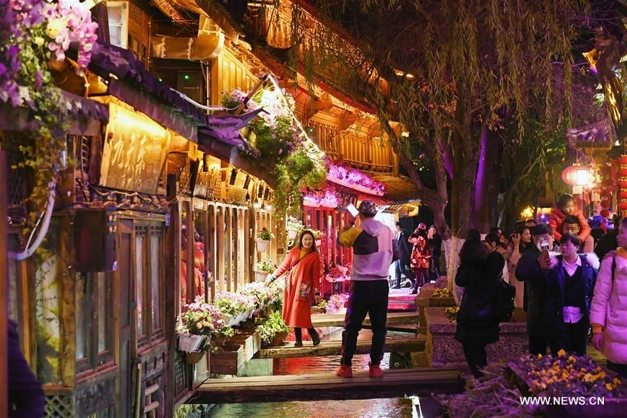 Tourists visit Lijiang ancient town in southwest China's Yunnan