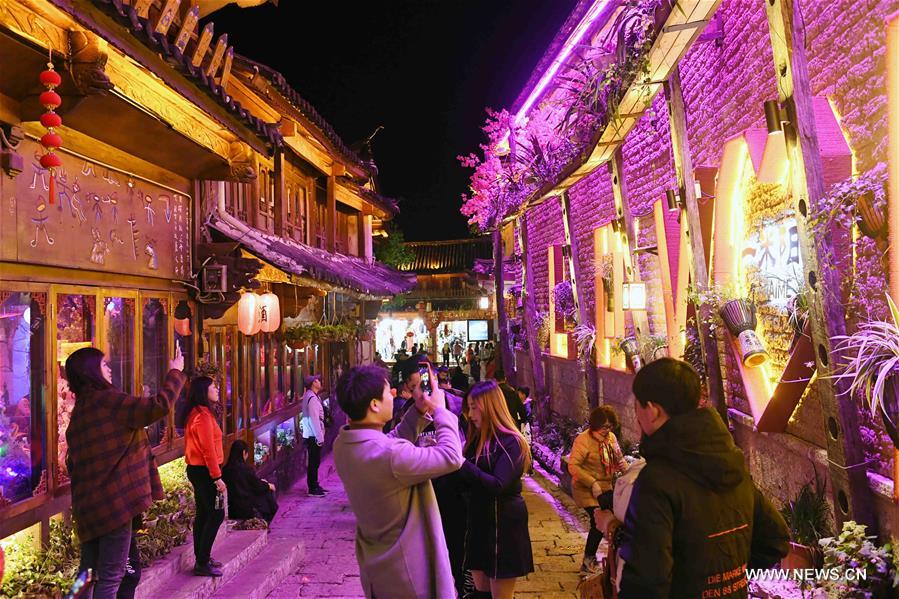 Tourists visit Lijiang ancient town in southwest China's Yunnan