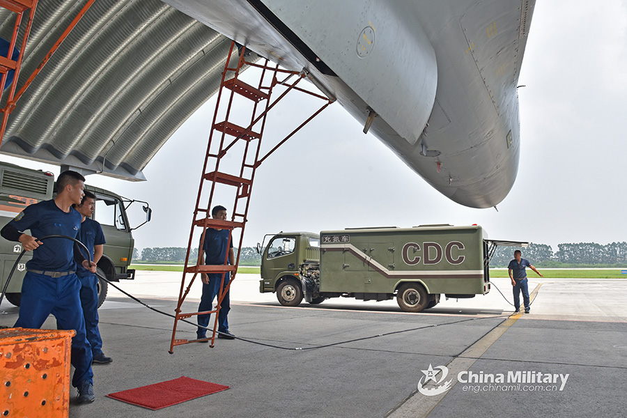 Airmen jointly load missiles before flight