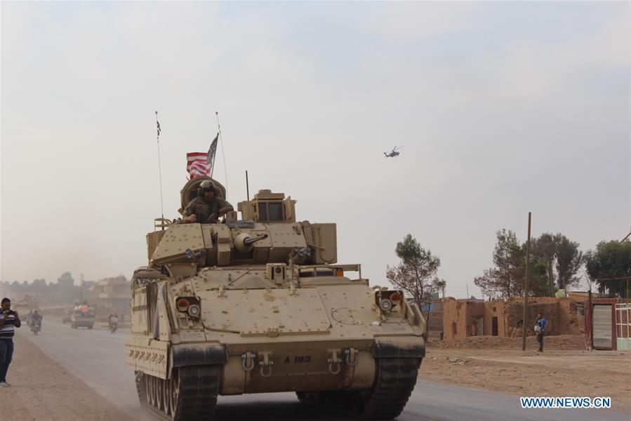 U.S. military vehicle runs past countryside of Hasakah province, NE Syria