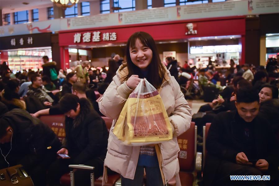 Passengers bring gifts for families as they head home for Spring Festival