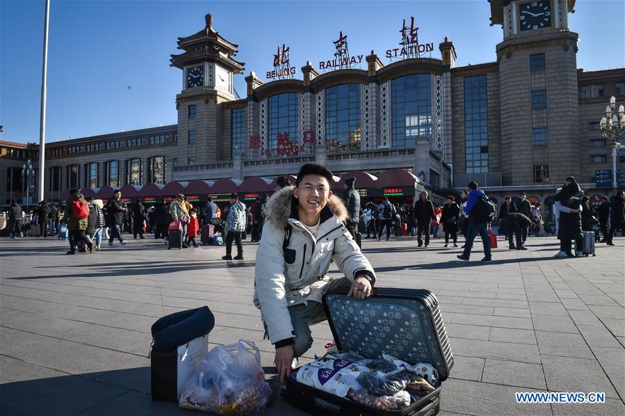 Passengers bring gifts for families as they head home for Spring Festival