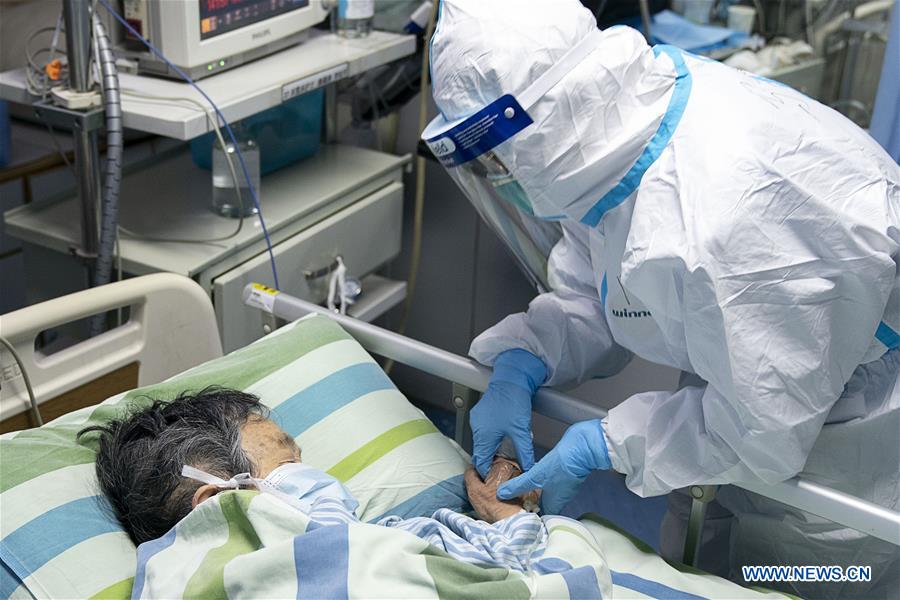 Medical workers take care of patients in Wuhan