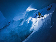 Daredevil snowboards in narrow ice cave