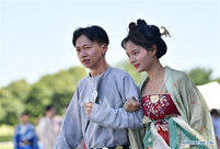 People wearing traditional costumes take part in Qixi event in Shaanxi