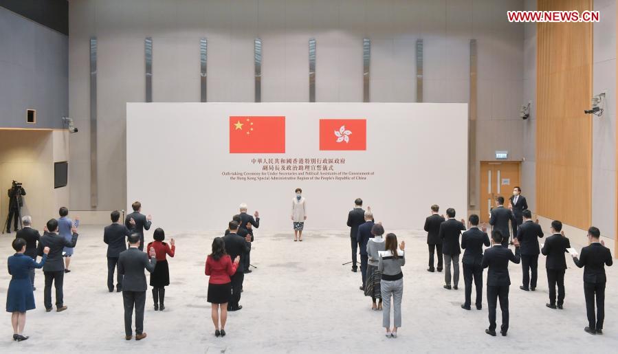 All the 12 under secretaries and 14 political assistants swear to uphold the Basic Law of the Hong Kong Special Administrative Region (HKSAR) of the People''s Republic of China (PRC) and swear allegiance to the HKSAR of the PRC during an oath-taking ceremony in Hong Kong, south China, Dec. 16, 2020. The HKSAR government held an oath-taking ceremony for under secretaries and political assistants, witnessed by the HKSAR Chief Executive Carrie Lam on Wednesday. (Xinhua)