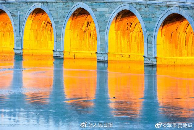 Stunning view of ancient bridge lit by golden winter sunshine at the Summer Palace in Beijing