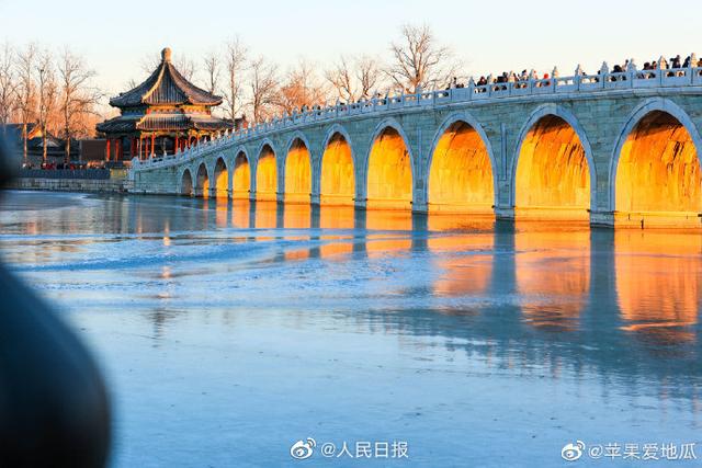 Stunning view of ancient bridge lit by golden winter sunshine at the Summer Palace in Beijing