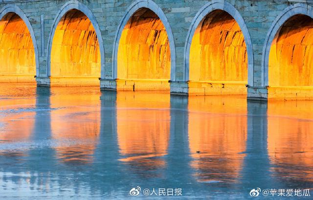 Stunning view of ancient bridge lit by golden winter sunshine at the Summer Palace in Beijing