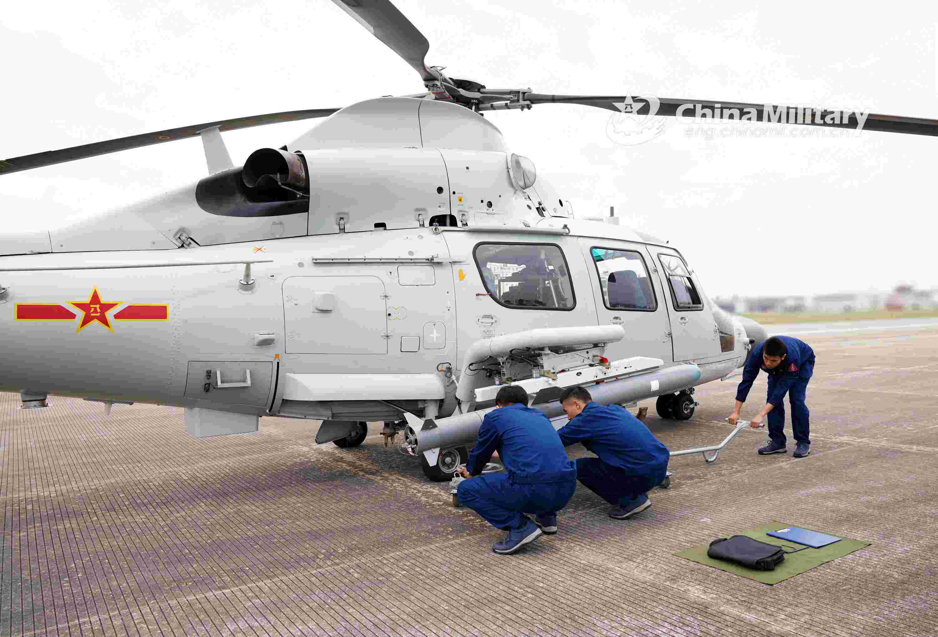 Ship-borne helicopters fire missiles