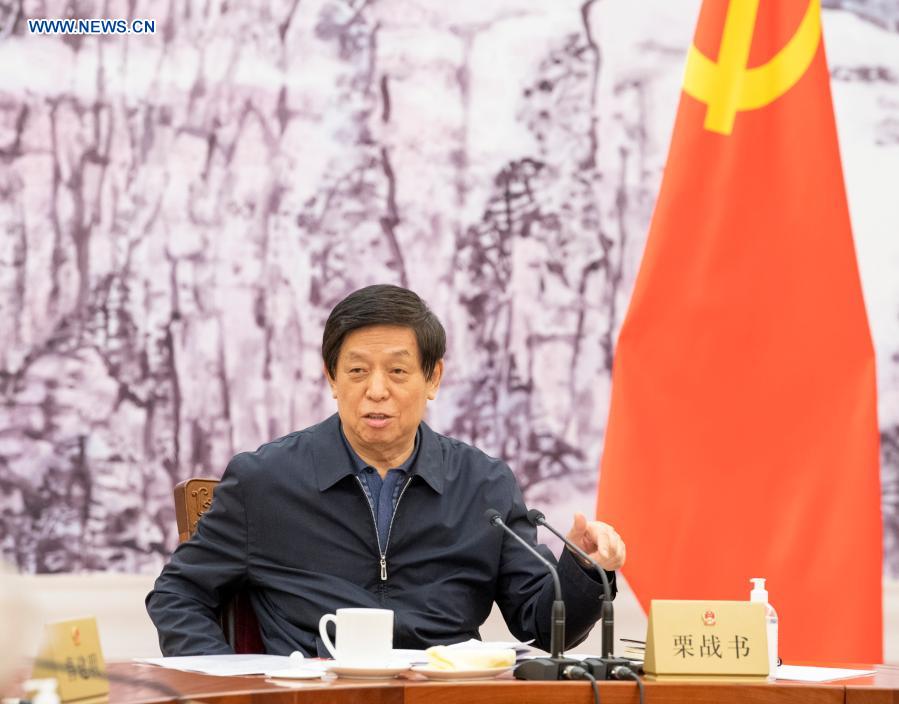 Li Zhanshu, a member of the Standing Committee of the Political Bureau of the Communist Party of China (CPC) Central Committee, chairman of the National People’s Congress (NPC) Standing Committee and secretary of its leading Party members group, presides over a meeting of the leading Party members group of the Standing Committee of the NPC, Jan. 26, 2021. Senior Chinese legislators have met to study an important speech delivered by Xi Jinping, general secretary of the Communist Party of China (CPC) Central Committee, at the fifth plenary session of the 19th Central Commission for Discipline Inspection of the CPC, as well as the guiding principles of the session. (Xinhua/Gao Jie)