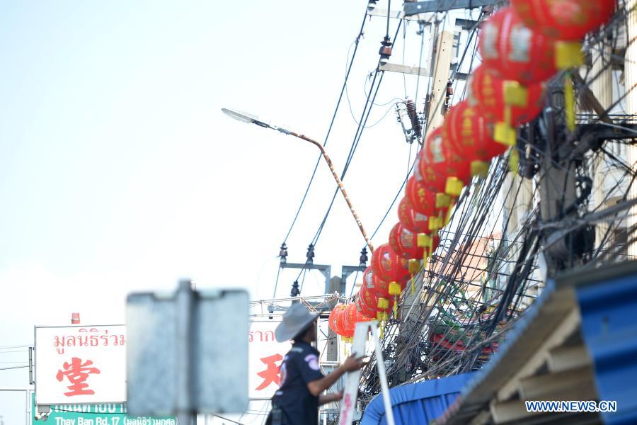 Staff members arrange lanterns to decorate street for upcoming Chinese Lunar New Year