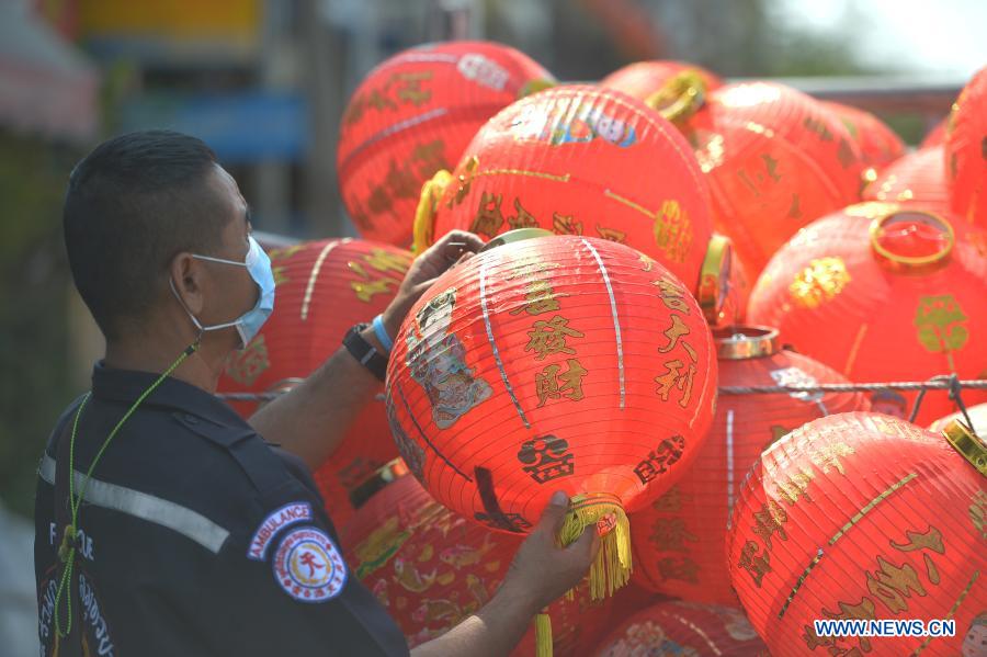 Staff members arrange lanterns to decorate street for upcoming Chinese Lunar New Year