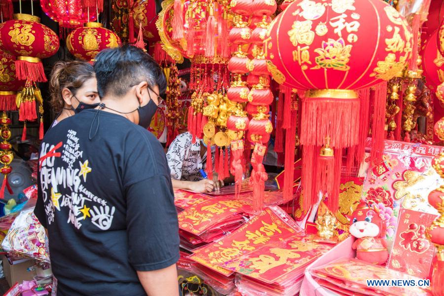 People buy spring couplets and other decorations for upcoming Chinese Lunar New Year in Bangkok