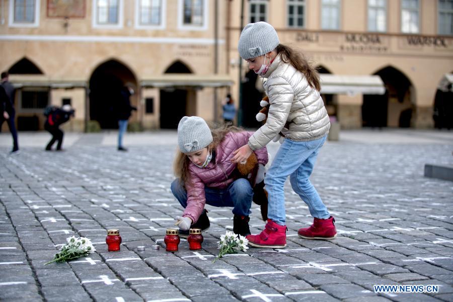 Old Town Square painted with white crosses in memory of victims of COVID-19 pandemic in Prague