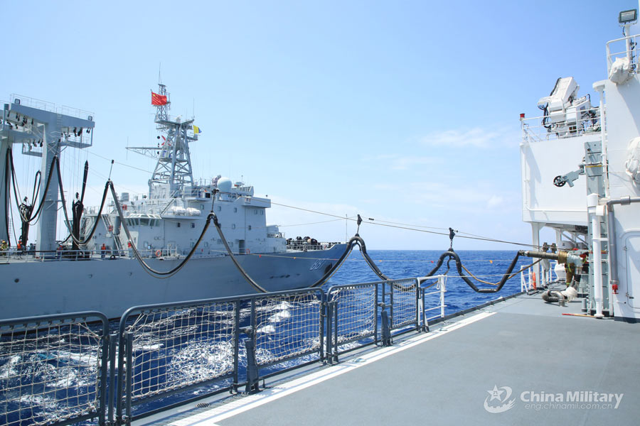 Navy vessels perform underway replenishment