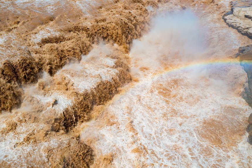 Rainbow appears over Hukou Waterfall on Yellow River