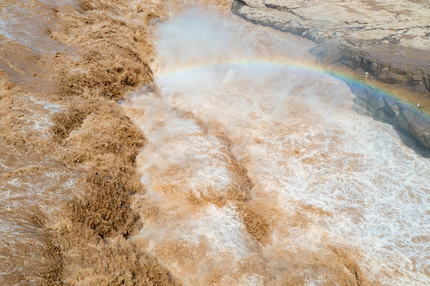 Rainbow appears over Hukou Waterfall on Yellow River