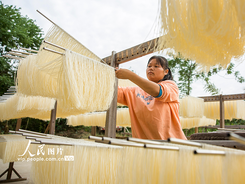 Residents dry fresh noodles at village in China's Jiangxi