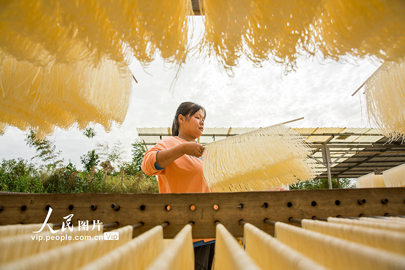 Residents dry fresh noodles at village in China's Jiangxi