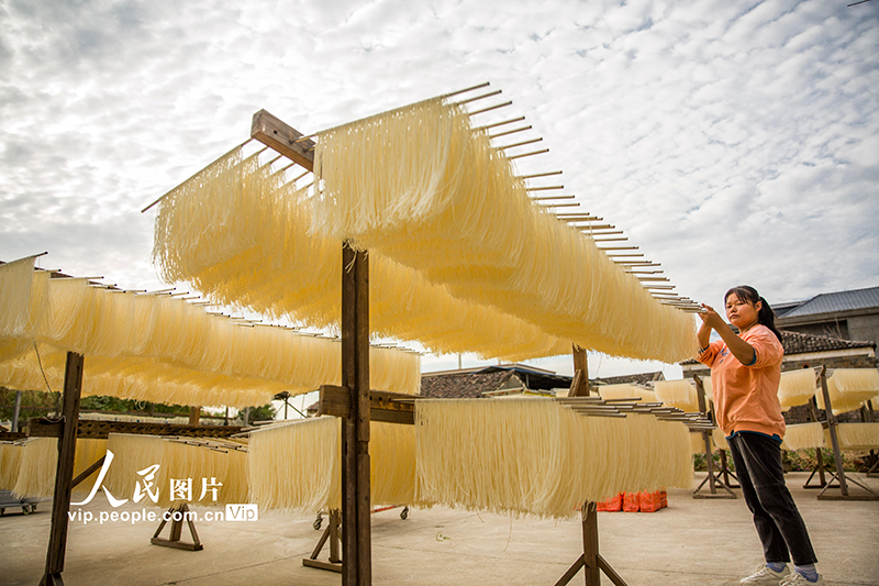 Residents dry fresh noodles at village in China's Jiangxi