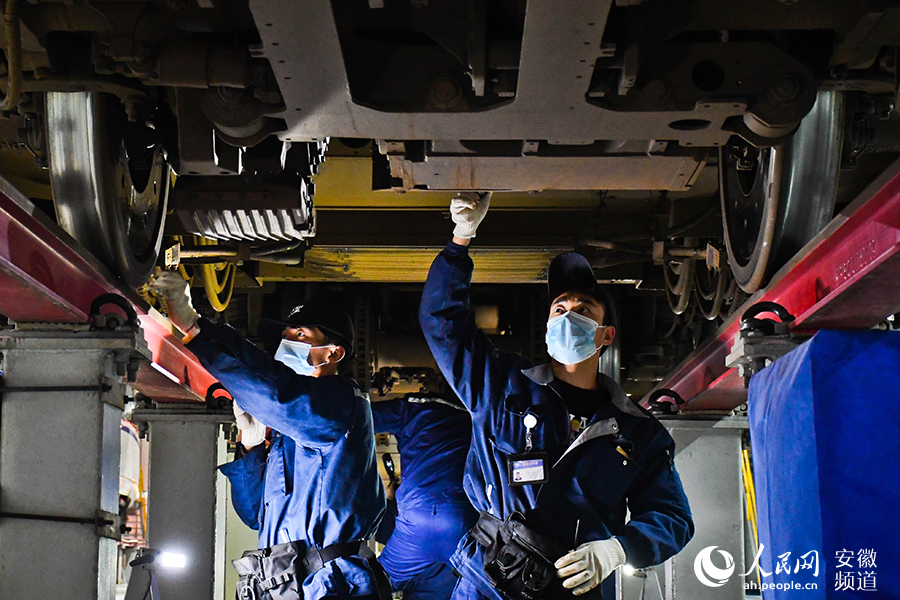 Young maintenance worker checks bullet trains for Spring Festival travel rush