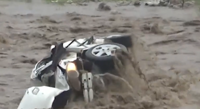 Firefighter rescues driver from raging flood