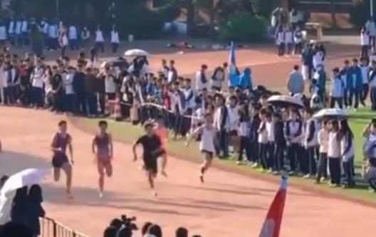 Boys sprint hand in hand across the finish line at high school sports meet