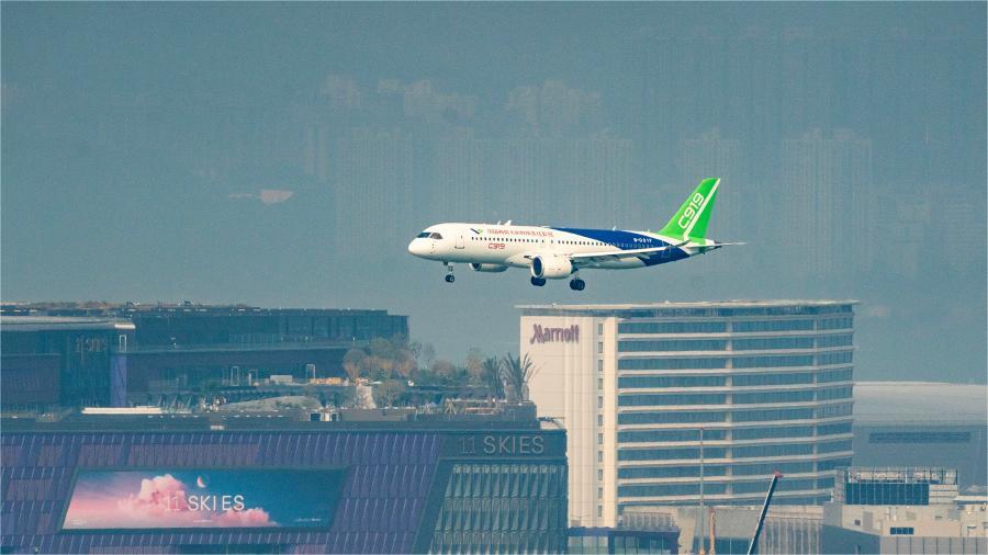 China's homegrown C919 aircraft flies over Victoria Harbor in Hong Kong