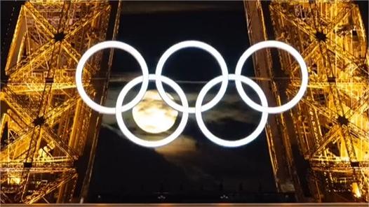 Moon and Olympic rings converge on Eiffel Tower in Paris