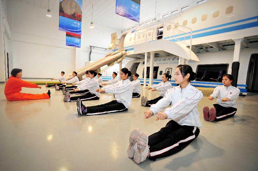 Students receive simulative training for Airbus A320 at the Cabin Attendant College of Civil Aviation University of China in north China's Tianjin, Nov. 2, 2012. (Xinhua/You Sixing)