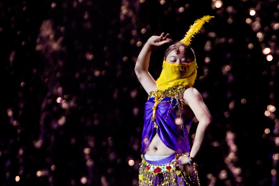 A dancer performs during a tourism dance "Tengchong Dream" in Tengchong County of southwest China's Yunnan Province, Nov. 4, 2012. The large-scale tourism dance is a national-standard grand cultural banquet which takes Tengchong's history and local customs as the main contents and can perfectly reflect the local features of Tengchong. (Xinhua/Zheng Huansong) 