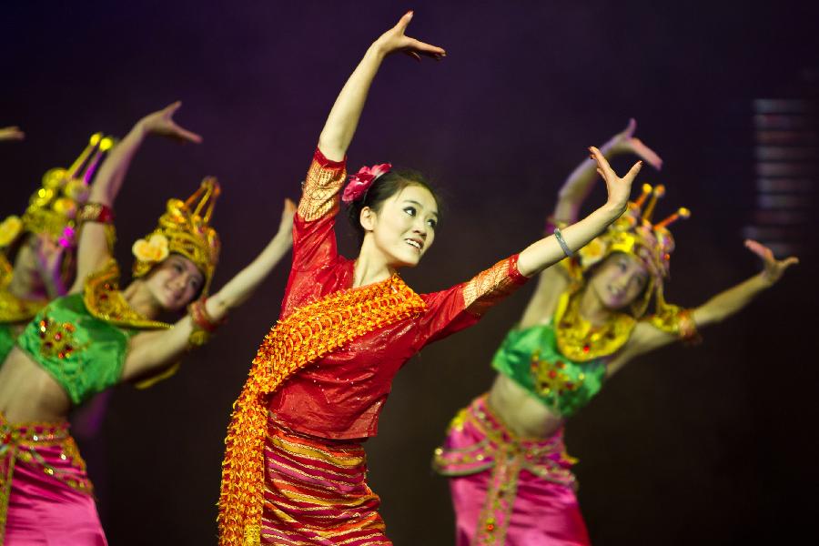 Dancers perform during a tourism dance "Tengchong Dream" in Tengchong County of southwest China's Yunnan Province, Nov. 4, 2012. The large-scale tourism dance is a national-standard grand cultural banquet which takes Tengchong's history and local customs as the main contents and can perfectly reflect the local features of Tengchong. (Xinhua/Zheng Huansong)