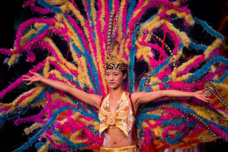 A dancer performs during a tourism dance "Tengchong Dream" in Tengchong County of southwest China's Yunnan Province, Nov. 4, 2012. The large-scale tourism dance is a national-standard grand cultural banquet which takes Tengchong's history and local customs as the main contents and can perfectly reflect the local features of Tengchong. (Xinhua/Zheng Huansong)