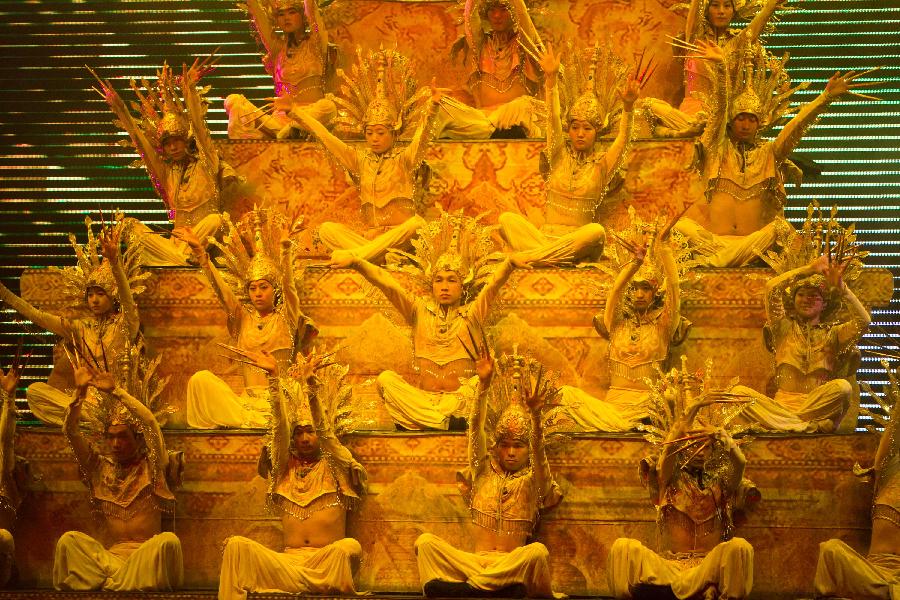 Dancers perform during a tourism dance "Tengchong Dream" in Tengchong County of southwest China's Yunnan Province, Nov. 4, 2012. The large-scale tourism dance is a national-standard grand cultural banquet which takes Tengchong's history and local customs as the main contents and can perfectly reflect the local features of Tengchong. (Xinhua/Zheng Huansong)